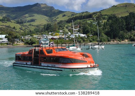 BANKS PENINSULA, NEW ZEALAND, DECEMBER 22, 2011 - A ferry carries people to a cruise ship in Akaroa Harbour since Christchurch port was damaged by earthquake; Banks Peninsula, New Zealand, 22-12-2011
