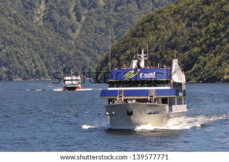 MILFORD SOUND, NEW ZEALAND, JANUARY 8: A launch carries crowds of passengeres on January 8, 2011 at Milford Sound in New Zealand. Milford is one of the country\'s  favourite tourist destinations.