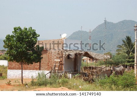 Satellite dish on small house, Tamil Nadu, South India