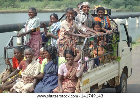 TAMIL NADU, INDIA, circa 2009: Unidentified women heading out in an overloaded vehicle to work in the rice paddies circa 2009 in Tamil Nadu, India