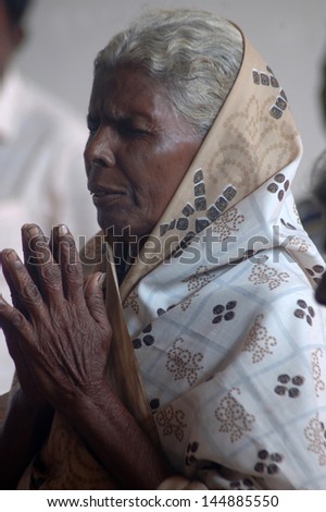 TIRUNELVELI, TAMIL NADU, INDIA, circa 2009: An unidentified woman prays in a Christian meeting, circa 2009, Tirunelveli, Tamil Nadu, India. Catholics & Protestants are less than 5 % of the population.