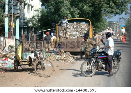 TIRUNELVELI, TAMIL NADU, INDIA, circa 2009: Garbage collectors pause in their work, circa 2009 near Tirunelveli, Tamil Nadu, India. India\'s cities are strewn with rubbish.