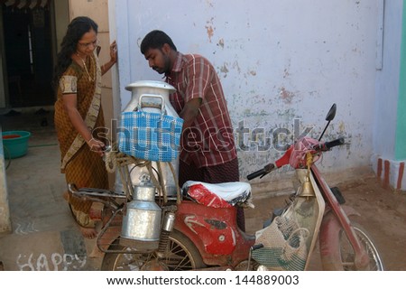 KALAKAD, TAMIL NADU, INDIA, circa 2009: Unidentified man delivers milk door to door, circa 2009 in the village of Kalakad, Tamil Nadu, India. India has the largest dairy industry in the world.
