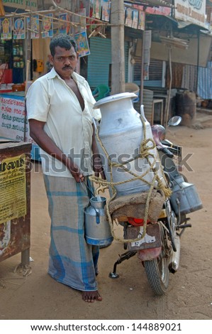 KALAKAD, TAMIL NADU, INDIA, circa 2009: An unidentified milkman makes his deliveries, circa 2009 in Kalakad, Tamil Nadu, India. India has the world\'s largest dairy industry.