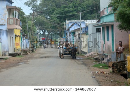 CHERANMAHADEVI, TAMIL NADU, INDIA, circa 2009: An unidentified man and his ox cart come to town, circa 2009 in Cheranmahadevi, Tamil Nadu, India. Ox carts are common in rural India.