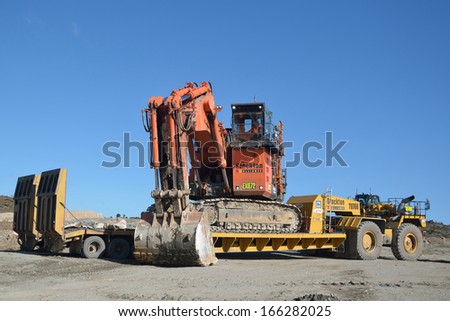 WESTPORT, NEW ZEALAND, AUGUST 31, 2013: Men load a 190 ton digger at Stockton coal mine on August 31, 2013 near Westport, New Zealand. Stockton is the country\'s largest open cast coal mine.