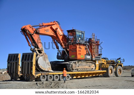 WESTPORT, NEW ZEALAND, AUGUST 31, 2013: Men load a 190 ton digger at Stockton coal mine on August 31, 2013 near Westport, New Zealand. Stockton is the country\'s largest open cast coal mine.
