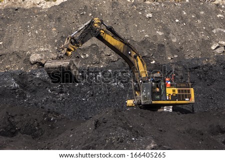 WESTPORT, NEW ZEALAND, AUGUST 31, 2013: 40 ton digger removes high grade coal from a seam at an open cast coal mine on August 31, 2013 near Westport, New Zealand