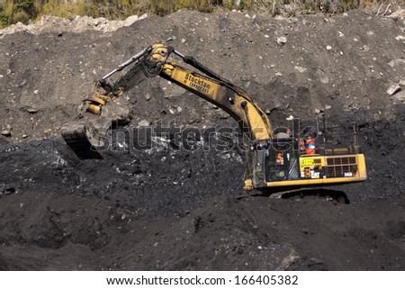 WESTPORT, NEW ZEALAND, AUGUST 31, 2013: 40 ton digger removes high grade coal from a seam at an open cast coal mine on August 31, 2013 near Westport, New Zealand