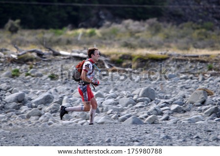 SOUTH ISLAND, NEW ZEALAND, FEBRUARY 12, 2011: Unidentified man competes in the mountain leg of the 2011 Coast to Coast triathlon, New Zealand