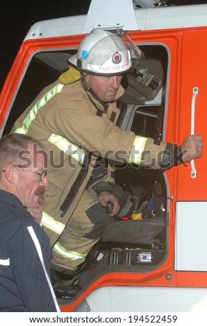 GREYMOUTH, NEW ZEALAND,  CIRCA 2006: Fire chief gives instructions from fire engine during an evening bushfire, Westland, New Zealand