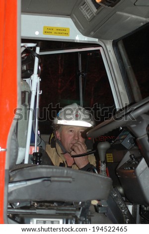 GREYMOUTH, NEW ZEALAND,  CIRCA 2006: Fire chief calls on radio  from fire engine to enlist help in fighting a bushfire, Westland, New Zealand
