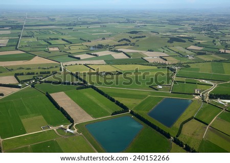Aerial of dairy and cropping farms in Canterbury, South Island, New Zealand. The large ponds collect effluent from the dairy farms for irrigation.