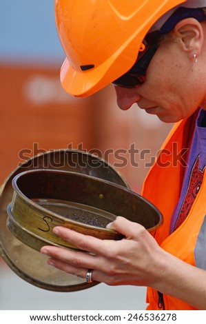 WHATAROA, NEW ZEALAND, DECEMBER 5, 2014: An unidentified geologist inspects rock samples while drilling to 1300 metres on the Deep Fault Drilling Project, Whataroa, New Zealand.