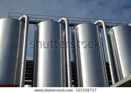 Storage silos contain cleaning chemicals for a milk factory