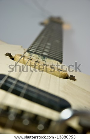 A heavily used electric guitar. Focus on 2nd pickup.