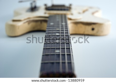 A heavily used electric guitar. Focus on 5th fret.