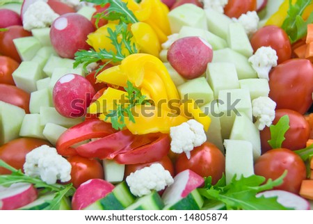 A vegetable dish with carrot, radish, cauliflower, lettuce, paprika, cucumber, iceberg lettuce