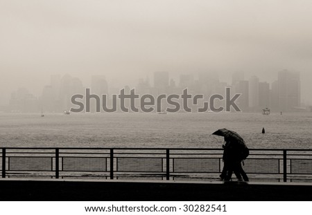 Manhattan skyline as seen from the Statue of Liberty island on a rainy day