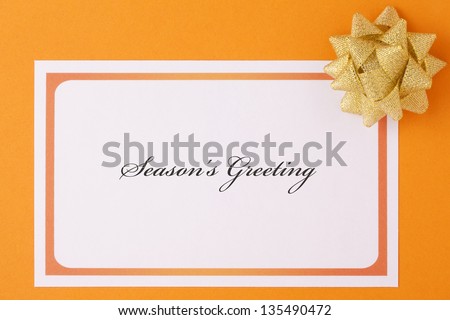 Golden bow with card and \'Season\'s Greeting\'