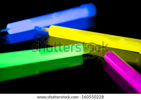 Closeup of multicolor glow sticks, with selective focus