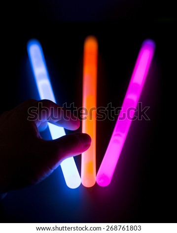 Glow sticks - A hand is going to pick up a glow stick