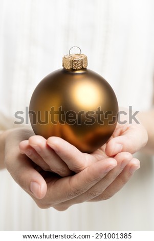 Christmas ball holding by hands
