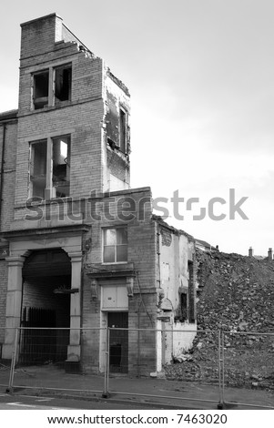 An old building cordoned off and in a state of demolition