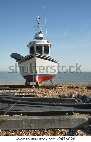 A fishing boat with the wire cable used to pull it onto the beach