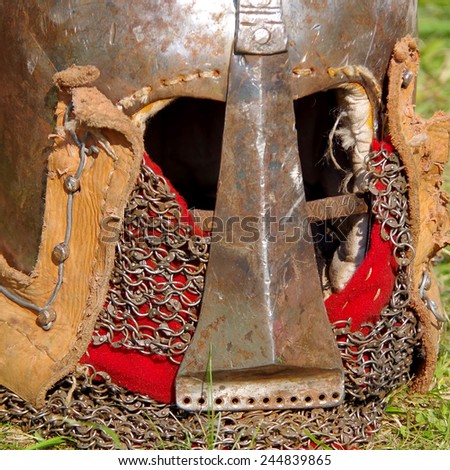 Iron helmet of the medieval knight on grass