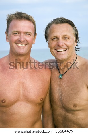 stock photo A color portrait of two happy mature gay men standing on the