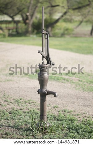 Antique hand well pump at an abandoned prairie homestead in Kansas.