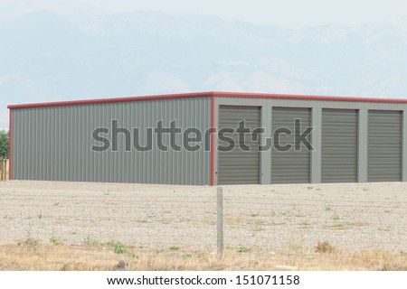 Rural storage unit facility with wire fence.