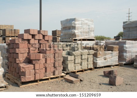 Pallet of red corner bricks at a building supply store.