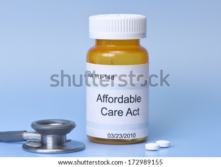 Affordable Care Act prescription bottle on blue with stethoscope and pills.