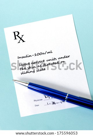 Prescription for insulin with blue pen on blue background.