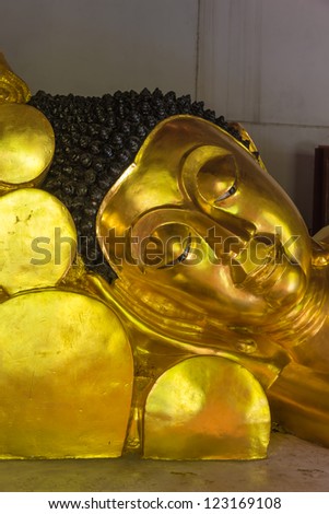 Golden Buddha sculpture Close-up to face at the temple, Thailand