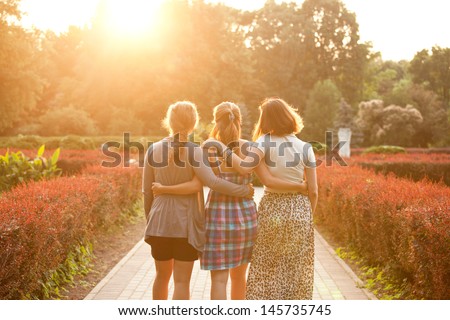 Three Girls Walking In The Sunset Park