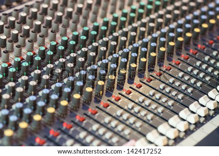 Detail of a music mixer in studio, dj working for a new song