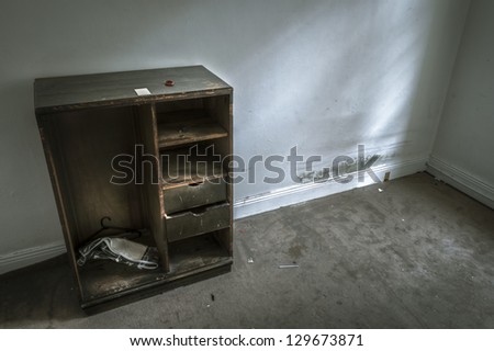 Dark, grungy, vacant domestic share house room interior with old wardrobe.