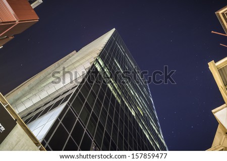 Tall glass office tower on a clear night - the BHP Billiton Centre in Melbourne, Australia.