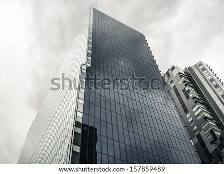 Tall glass office tower on an overcast day - the BHP Billiton Centre in Melbourne, Australia.