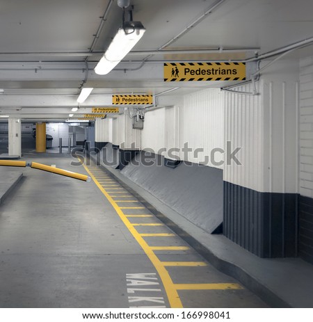 Pedestrian Walkway And Signage In An Undercover Parking Garage.