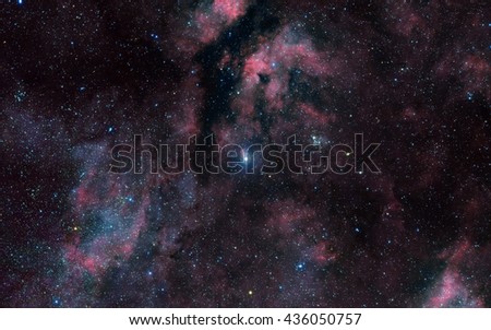 Deep space background filled with bright nebulae and shining stars.