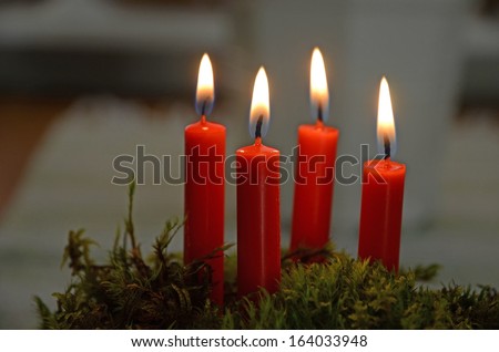Four red lighted candles
