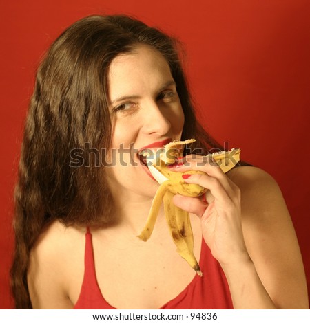 A woman eating a banana.