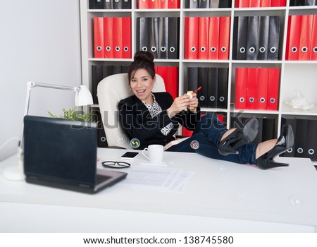 Business woman blowing soap bubbles in a break during working hours