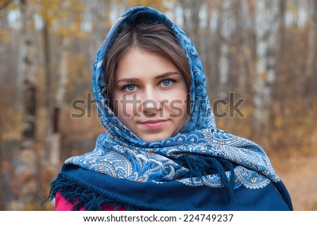 young woman in a blue handkerchief in autumn Park
