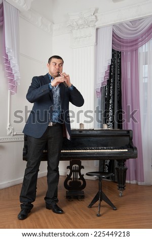 musician holds the instrument in the hands of the living room