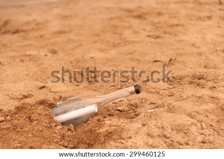 Paper a note in a bottle on the sand in the summer
